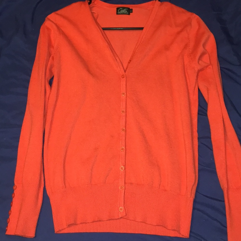 orange cardigan/sweater.